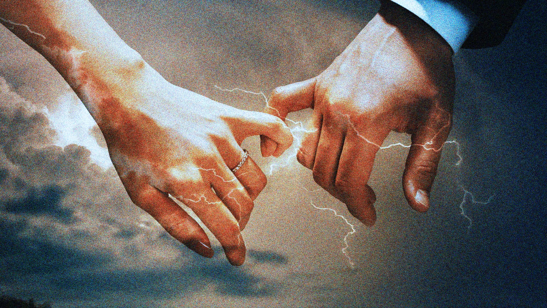 man and woman hands crossing pinkys with lightning spark